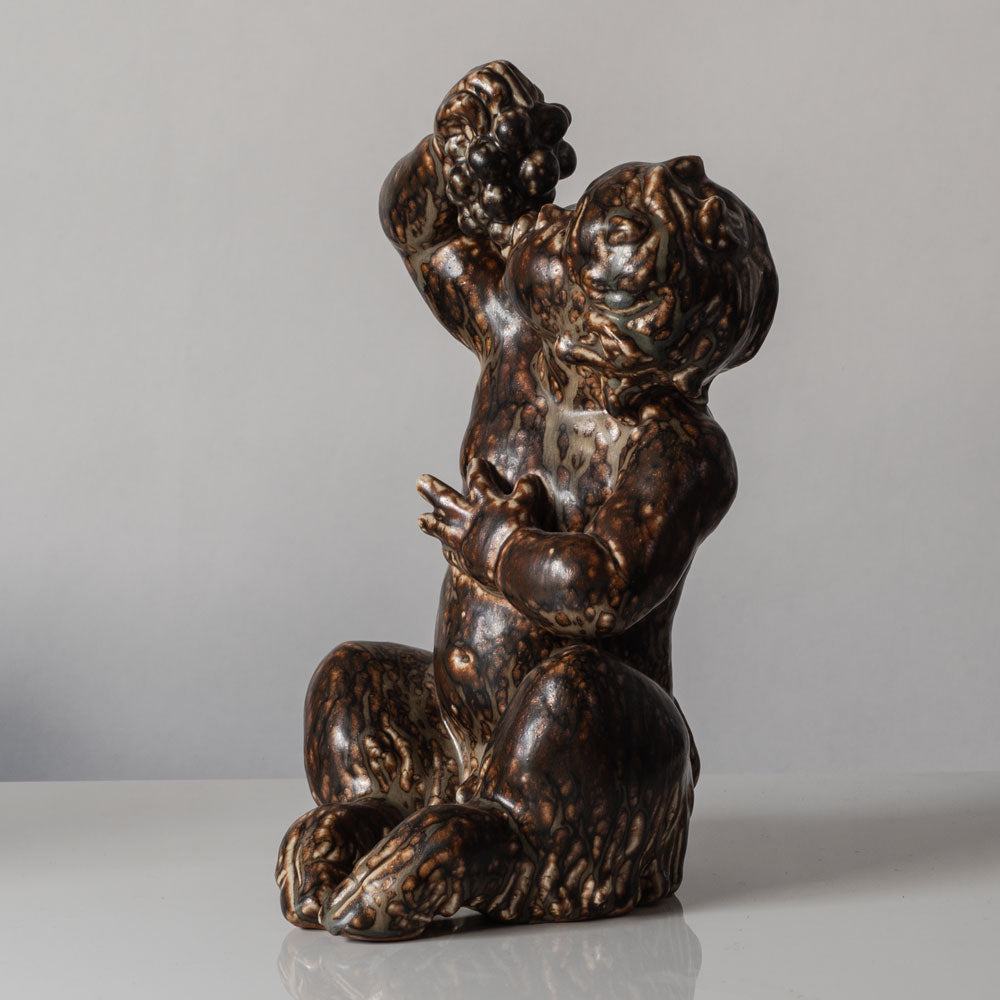Knud Kyhn for Royal Copenhagen, Denmark, stoneware faun figure eating grapes with Sung glaze