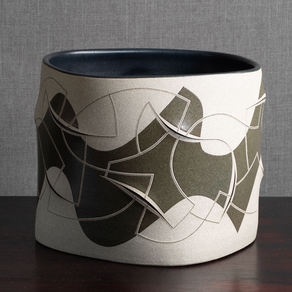 Gustavo Pérez, own studio, Mexico, irregularly shaped vessel with sliced exterior and matte black and beige glaze M4295