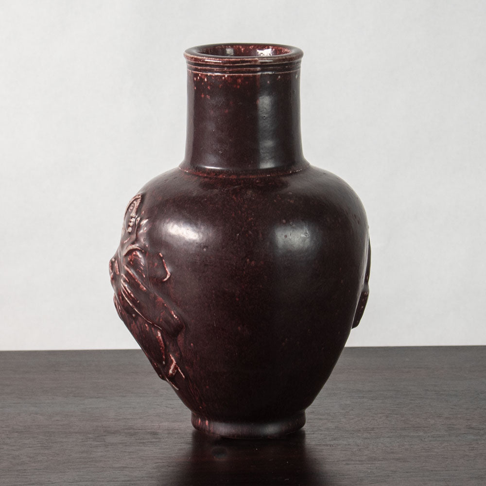 Jais Nielsen for Royal Copenhagen, Denmark, stoneware vase with figures in relief and oxblood glaze N2308