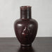 Jais Nielsen for Royal Copenhagen, Denmark, stoneware vase with figures in relief and oxblood glaze N2308
