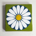 Bengt Berglund for Gustavsberg, enamel wall hanging with flower image in green, white, blue and yellow M5433