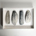 Ulla Viotti, Sweden, four stoneware forms mounted on wooden frame L3904