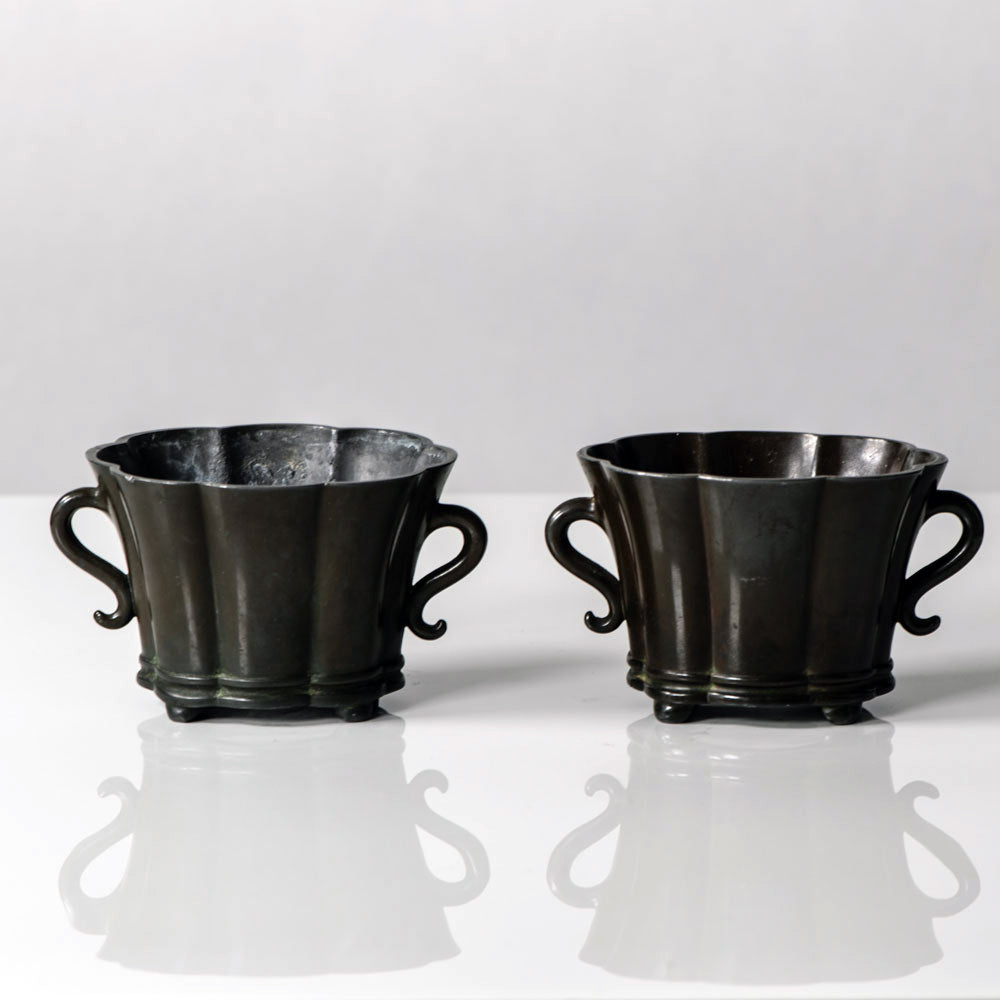 Just Andersen, Denmark, Pair of handled scalloped vessels in disko metal