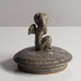 Stoneware lid with figure of cherub with green matte glaze by Arne Bang J1091