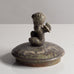 Stoneware lid with figure of cherub with green matte glaze by Arne Bang J1091