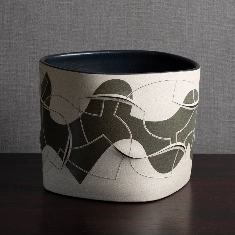 Gustavo Pérez, own studio, Mexico, irregularly shaped vessel with sliced exterior and matte black and beige glaze M4295