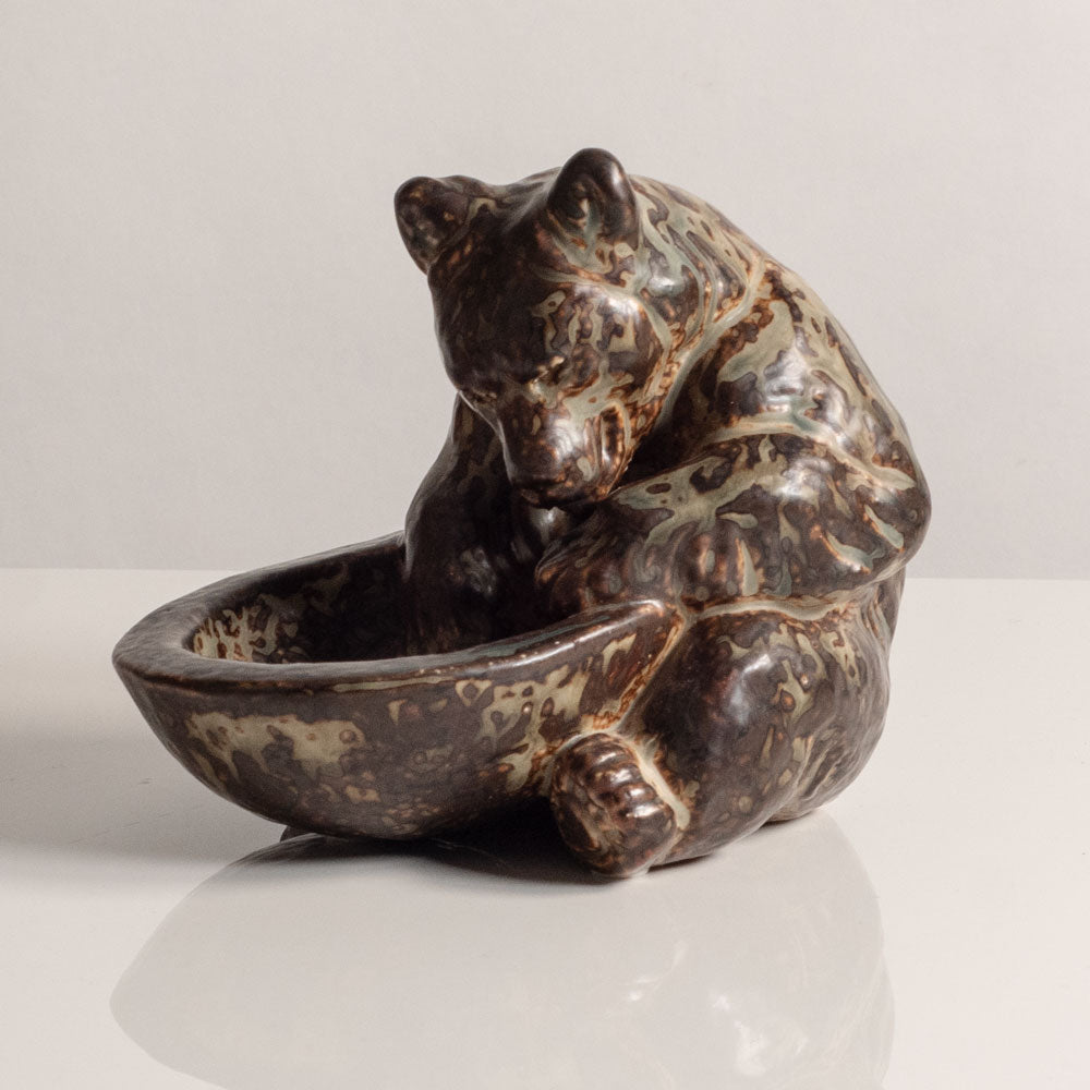 Knud Kyhn for Royal Copenhagen, Denmark, stoneware figure of a bear with a bowl M5757
