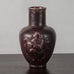 Jais Nielsen for Royal Copenhagen, Denmark, stoneware vase with figures in relief and oxblood glaze N2308