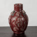 Jais Nielsen for Royal Copenhagen, Denmark, stoneware vase with oxblood glaze and figures in relief N1243